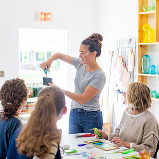 Teacher demonstrating artwork in fused glass class at The Glass Orchard