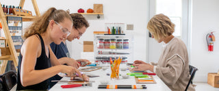 Students working on a glass fusing project at The Glass Orchard