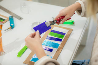 A student using glass fusing tools to create a project