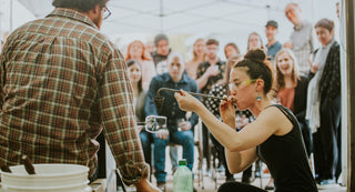 Crowd watching glass artist blow a glass art piece at The Glass Orchard 