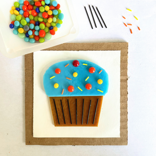 A fused glass cupcake being made