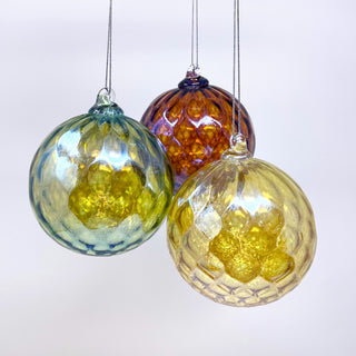 Three handblown glass ornaments hanging together