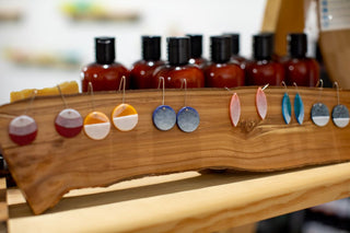 Local artist earrings on wooden display