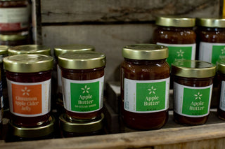 Photo of jarred goods, including apple butter and cider jelly. 