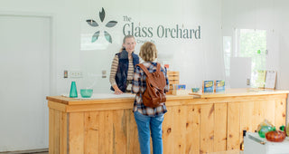 Employee and customer talking at the checkout counter at The Glass Orchard